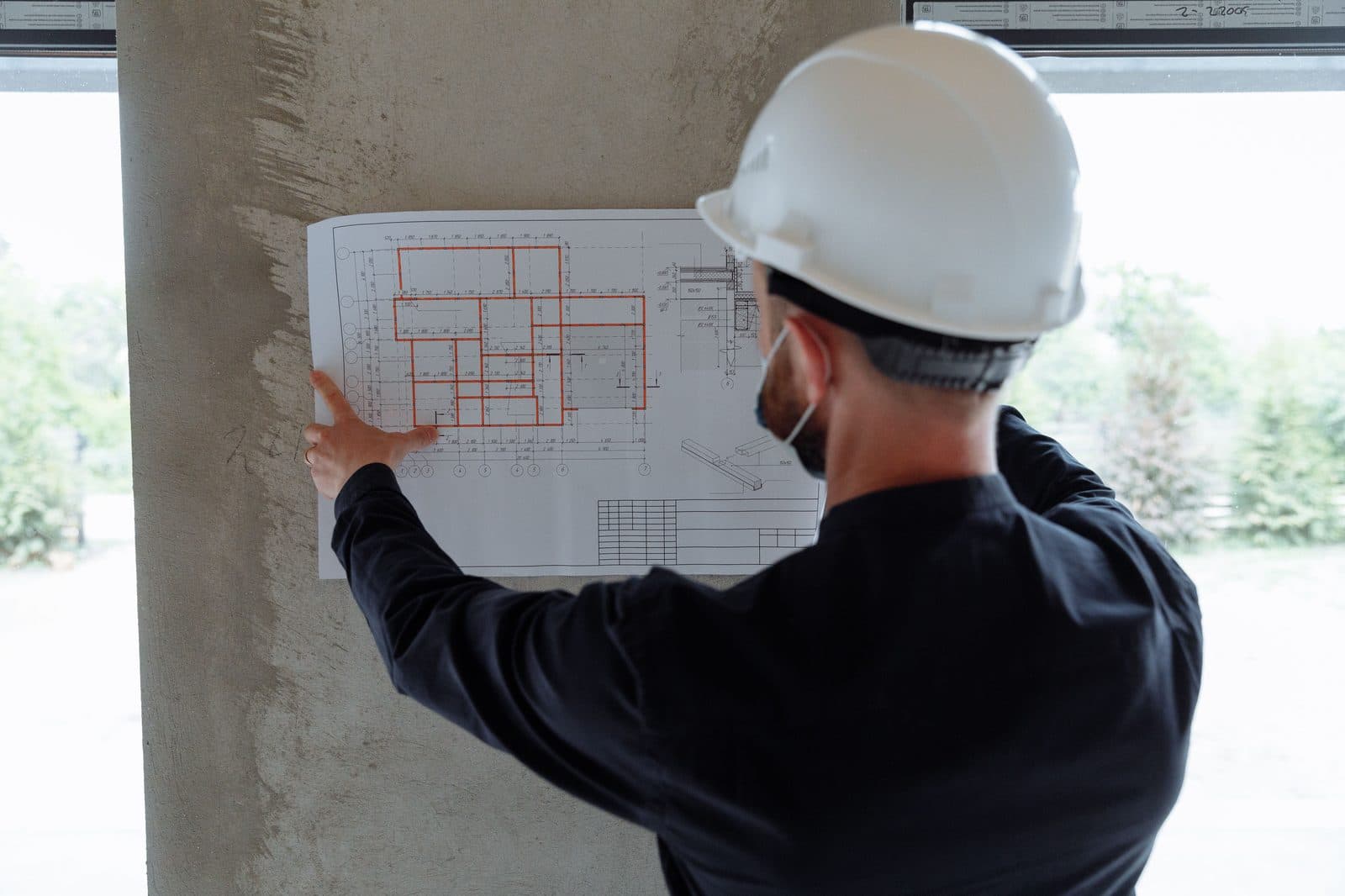 Consultant reviewing site plans, representing our hands-on approach