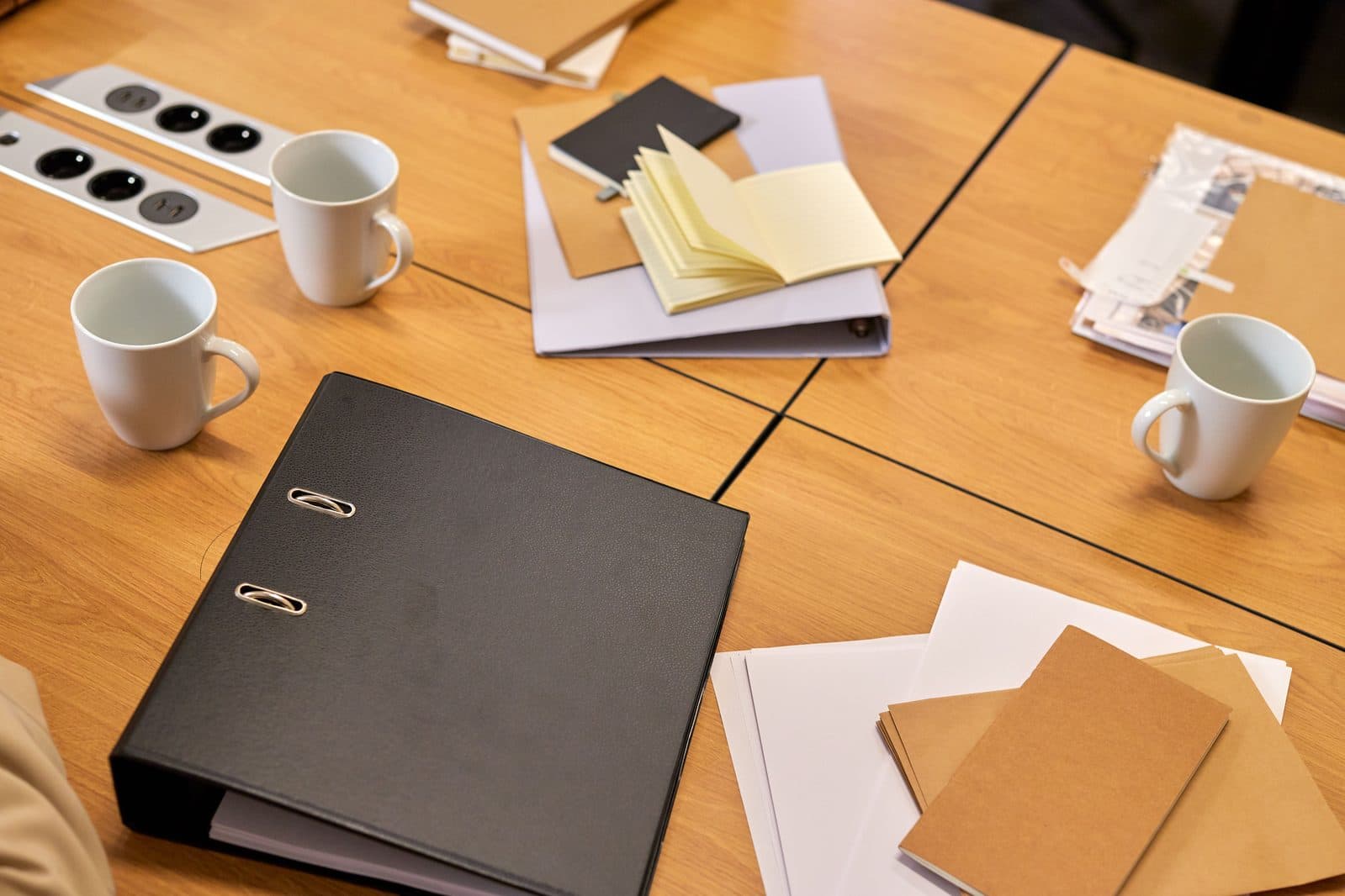Planning documents and notes laid out on a table, representing considered, tailored support